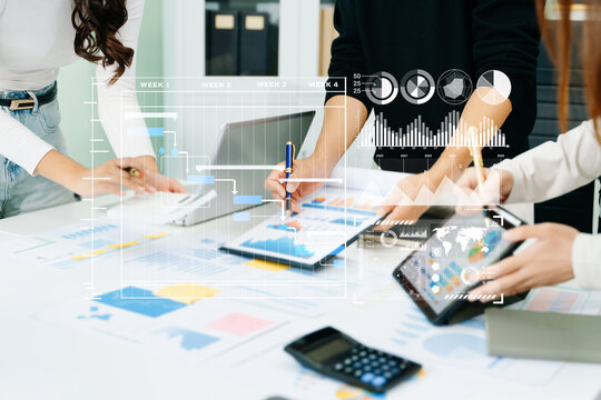 Businessman hand Project manager working and update tasks and Gantt chart scheduling virtual diagram.with smart phone, tablet and laptop in office.