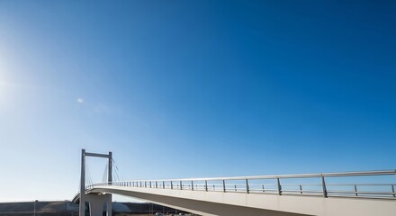 Obraz premium Modern bridge against a bright blue sky on a sunny day.