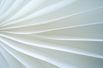 Obraz premium A close-up view of white, layered paper or material, creating a smooth, flowing texture that conveys elegance and simplicity.