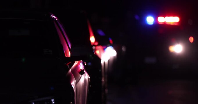 Abstracted view of police car pulling over a vehicle on a city street at night.