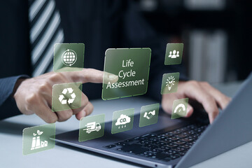 LCA, Life cycle assessment concept. Carbon footprint evaluation and environmental impact assessment related to product value chains. Businessman use laptop with virtual icons.
