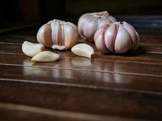 A bunch of fresh garlic on a wooden board. Garlic for cooking.