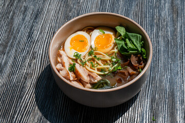 Ramen soup in cafe on wooden table. 