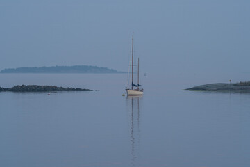 Sails down, night falls in blue