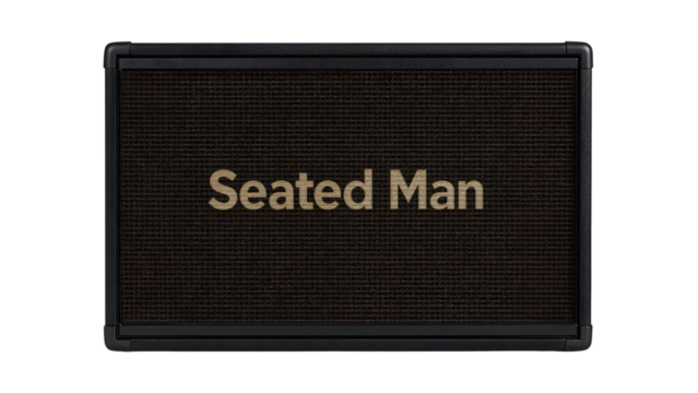 Rectangular black guitar amplifier with dark brown speaker grill and text seated man centered on front panel isolated on the transparent background