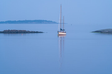 Sails down, night falls in blue