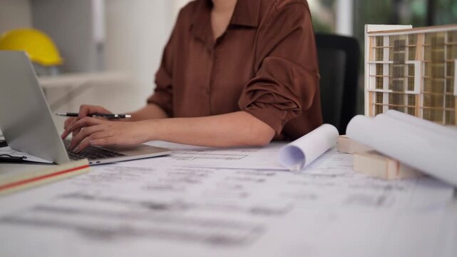 Architect professional designs urban structures plans projects using digital tools technology in modern office workspace for construction development innovation