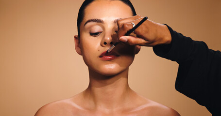 Beauty, hand and woman with lipstick brush, makeup artist and cosmetics for facial shine. Space,...