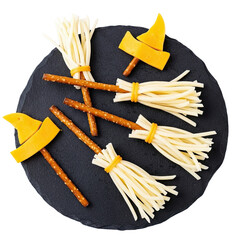 Creative halloween witch broom snacks made from string cheese and pretzel sticks isolated on transparent background