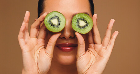 Beauty, kiwi and eyes with woman in studio for vitamin c, skincare and antioxidants glow. Self...