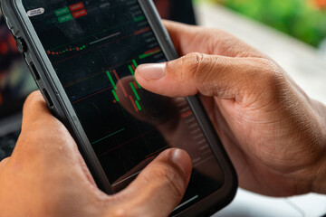 Professional using notebook and smartphone in a cafe setting, representing business, trade, finance, remote working, and productivity in a modern workspace lifestyle.