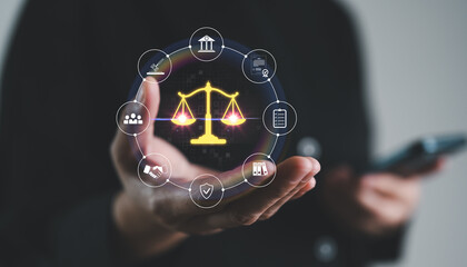 Businesswoman holding justice scale with legal icons around, law, court, legal system, compliance, digital justice and legal service technology in modern business operations. Corporate regulation.