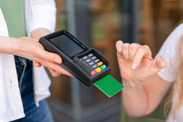 Payment process at a cafe with a card reader during a busy afternoon