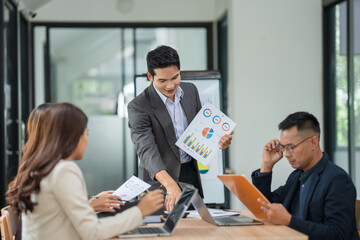 Asian business group meets to explain presentations and plan business and investment projects.