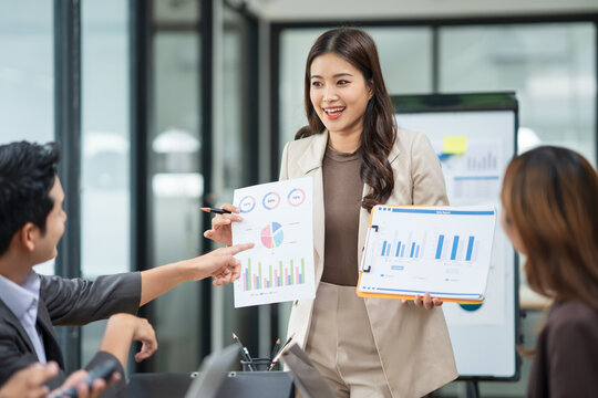 Group of Asian business people meeting and presenting work in the office	 - Powered by Adobe