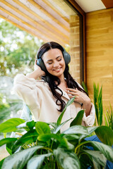 Relaxed woman enjoying free time, listening to music.