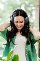 Relaxed woman enjoying free time, listening to music.