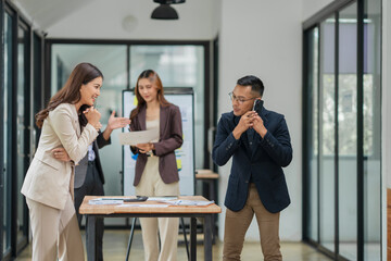 Asian business group meets to explain presentations and plan business and investment projects.