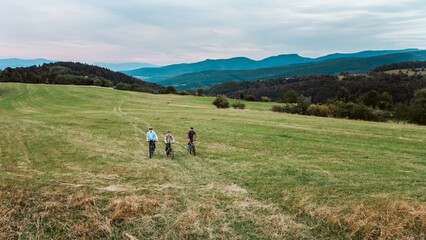 Areal view of grandfather, father and teen boy during biking trip.
