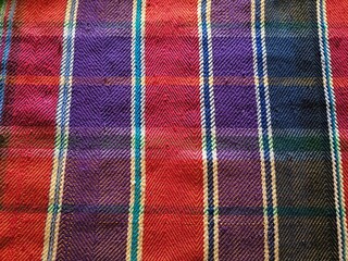 Colorful woven plaid fablic texture tartan pattern close up