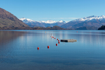 Tranquil Lake Wanaka and snowcapped mountains, South Island, New Zealand