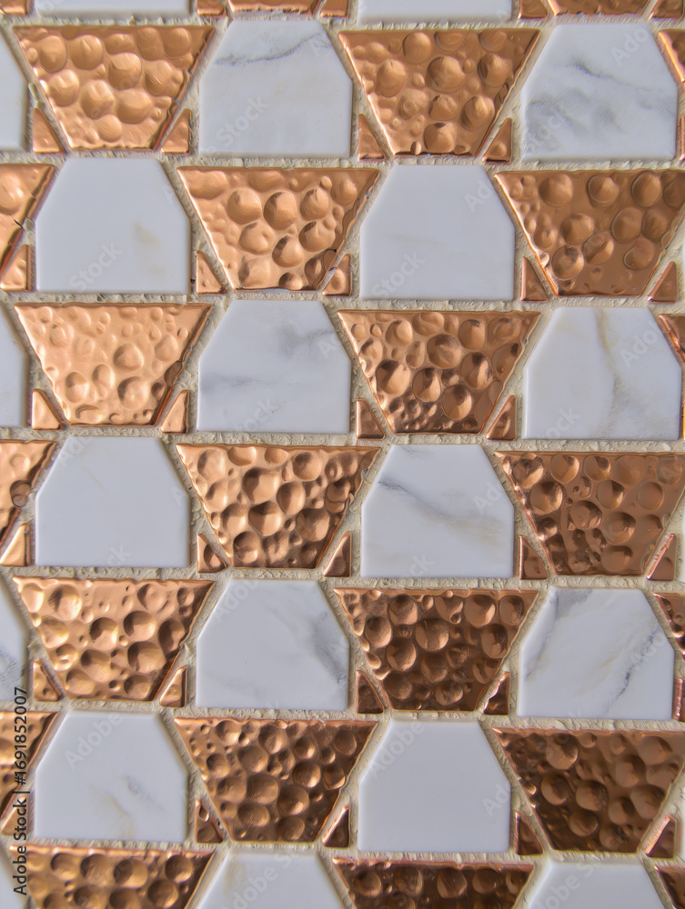 Poster close up of alternating copper and white geometric tiles forming a textured pattern design on a surf