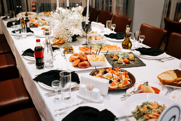 Elegant dinner table set with various dishes and drinks for a special occasion in a modern venue