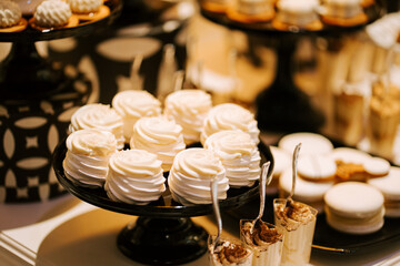 Elegant dessert display featuring cream cupcakes and sweet treats at a celebration event