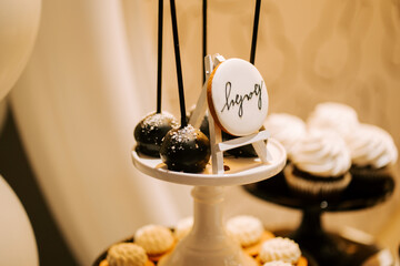 Elegant dessert display featuring cake pops and cookies at a celebration event