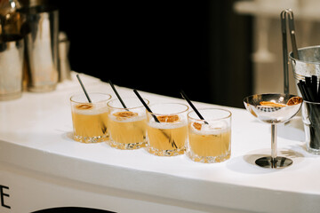 Refreshing cocktails lined up at a modern bar during an evening gathering