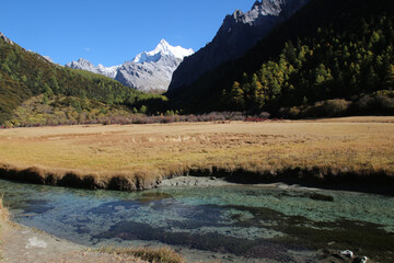 Majestic snow peaks tower over serene alpine rivers and lakes  Yading Nature Reserve, Sichuan, China