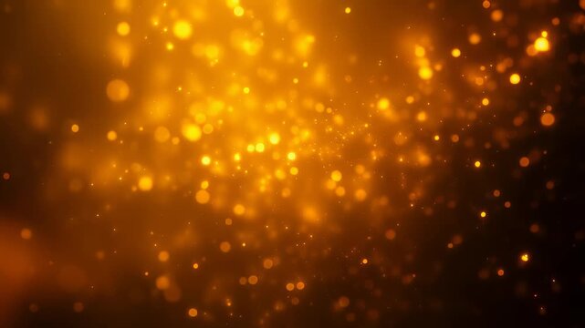 Golden light particles on a dark background with bokeh effect