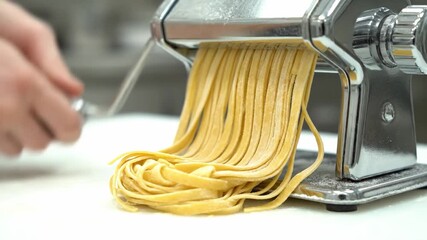 Discover the art of making fresh pasta using a classic pasta machine in a charming kitchen. Watch as the dough transforms into perfect ribbons of pasta, ready for your favorite sauce.