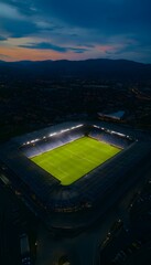 High Aerial View of Modern Soccer Stadium at Dusk
