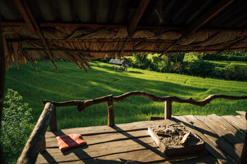 Wooden balcony with rice fields, view from the hut next to the rice fields