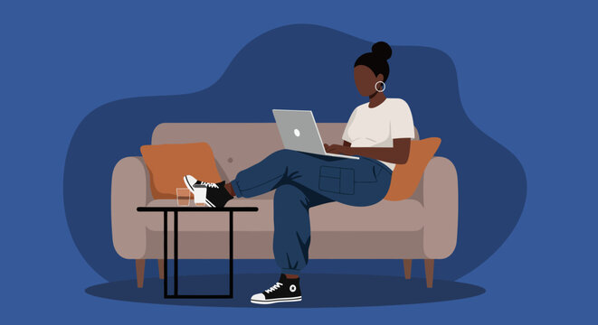 Young woman works remotely from home on a laptop, comfortably seated on a sofa. Represents freelance work, flexible lifestyle, and modern productivity.
