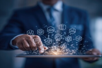 Businessman using tablet, holographic icons appear