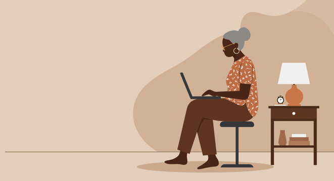 Senior Black woman working on a laptop at home, embracing technology for remote work, learning, or staying connected in a cozy, modern environment.