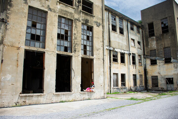 Traveler thai women people travel visit abandoned ruin ancient industrial building of Old Kanchanaburi Thai Paper Mill Industry Factory architecture of World War II landmarks in Kanchanaburi, Thailand