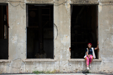 Travelers thai women people travel visit and portrait posing for take photo with abandoned ruins building of Kanchanaburi Thai Paper Mill Factory architecture of World War II in Kanchanaburi, Thailand