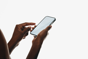 Close-up of hands making zoom gesture on smartphone with blank screen for mockups