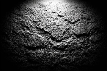 Gray stone surface with cracks and light source