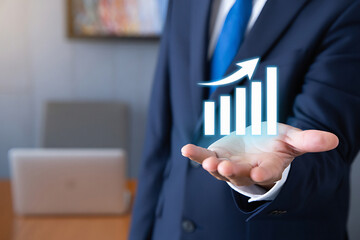 Business professional holding glowing bar graph with upward trending arrow symbolizing financial growth and success in modern office setting