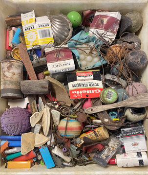 Container full of various random found objects, junk, rubbish and ephemera