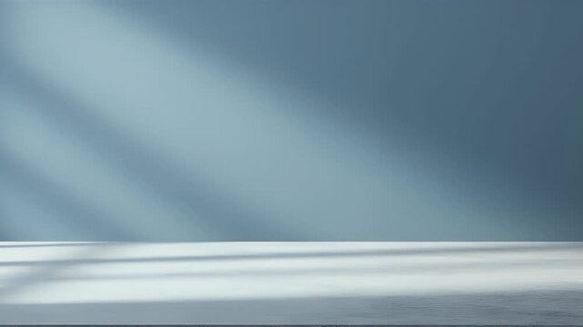Minimalist blue wall and white table background with diagonal window shadows for product display.