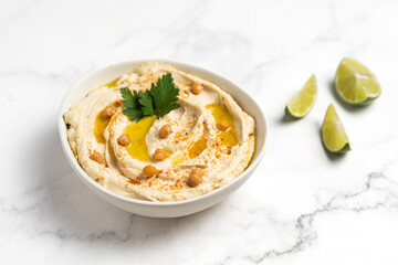 Homemade vegan hummus. Tasty vegan snack. Light background.