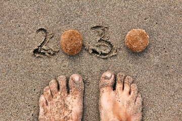 Human feet on sand with 