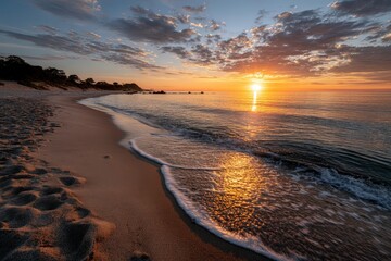 A beautiful beach with waves gently crashing against the shore at sunset