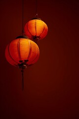 Obraz premium Two red lanterns hanging on the wall, a Chinese New Year atmosphere, a red background