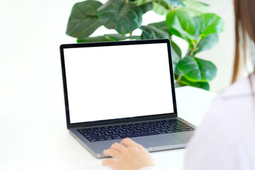 Fototapeta premium Laptop computer screen mockup, template background banner, Woman hand typing laptop computer with blank screen, Business online, e commerce, online study concept